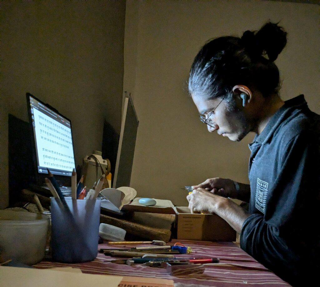 A woman sitting on the desk and working on computer 