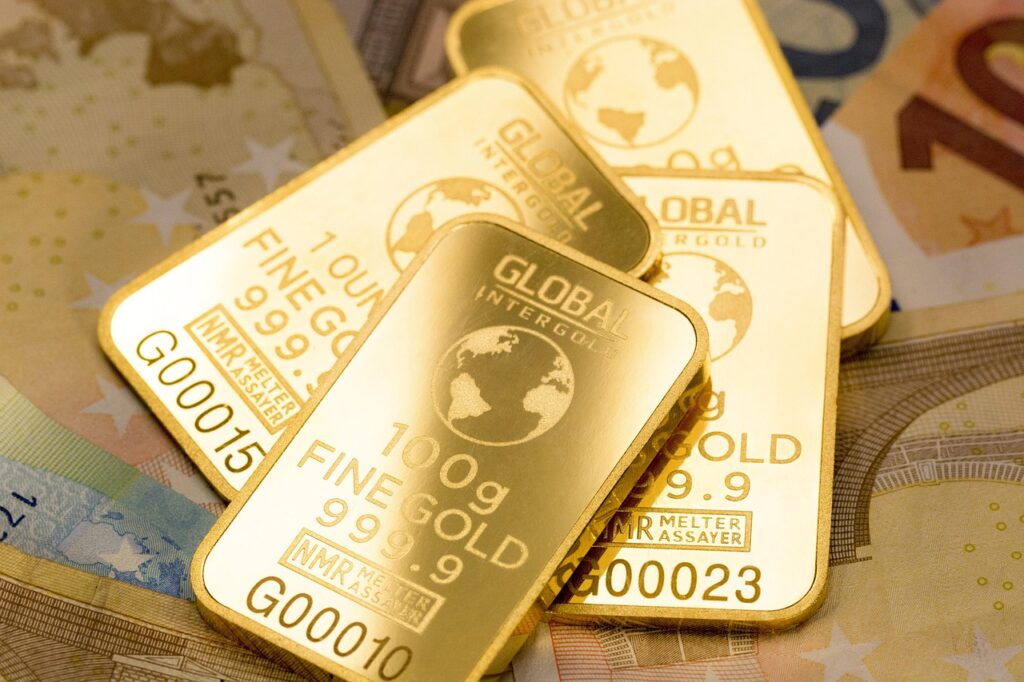 Gold bars embossed with "Global Intergold" and "100g Fine Gold" rest on Euro banknotes, conveying wealth and luxury.