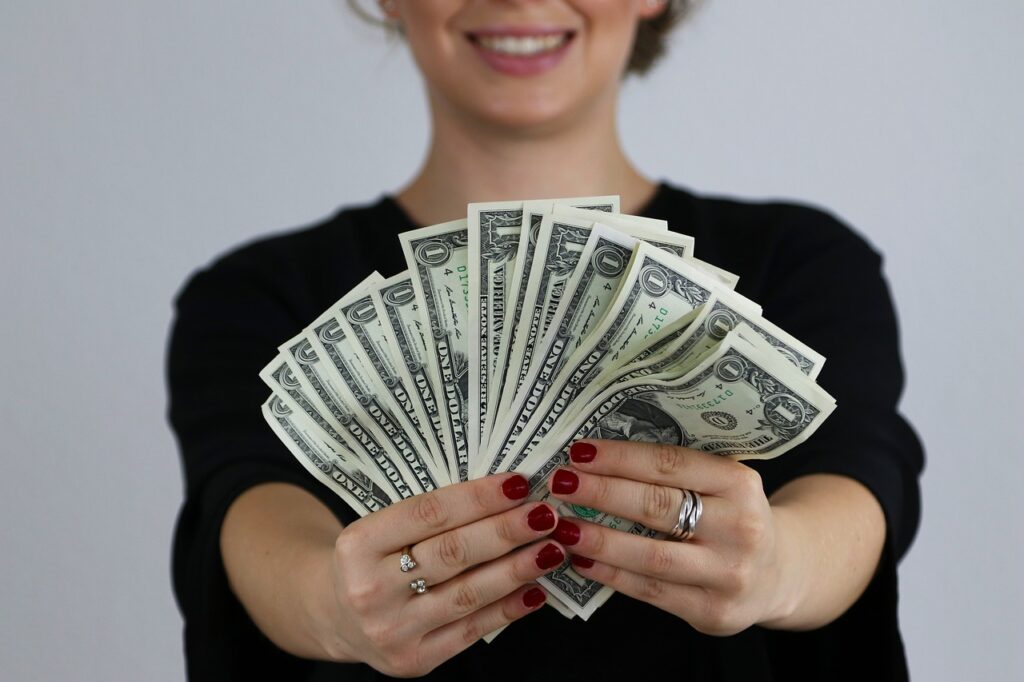 A girl is showing cash through her hand 